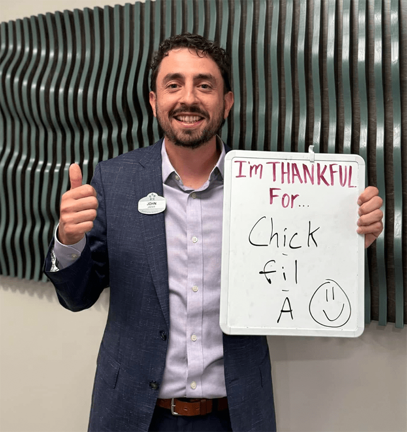 Staff member holding a sign expressing gratitude