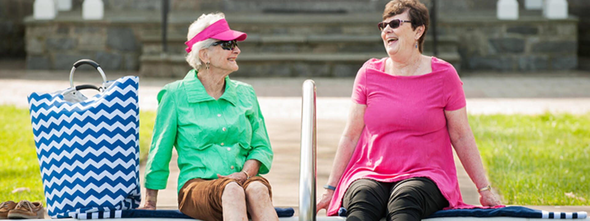 Two smiling residents enjoying the outdoor space