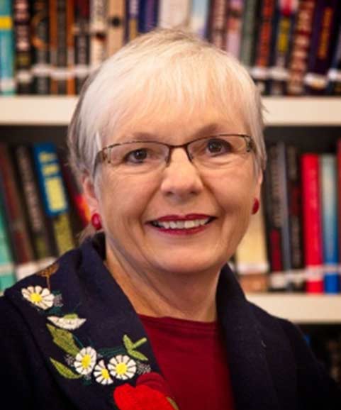 Portrait of a smiling older woman in a library