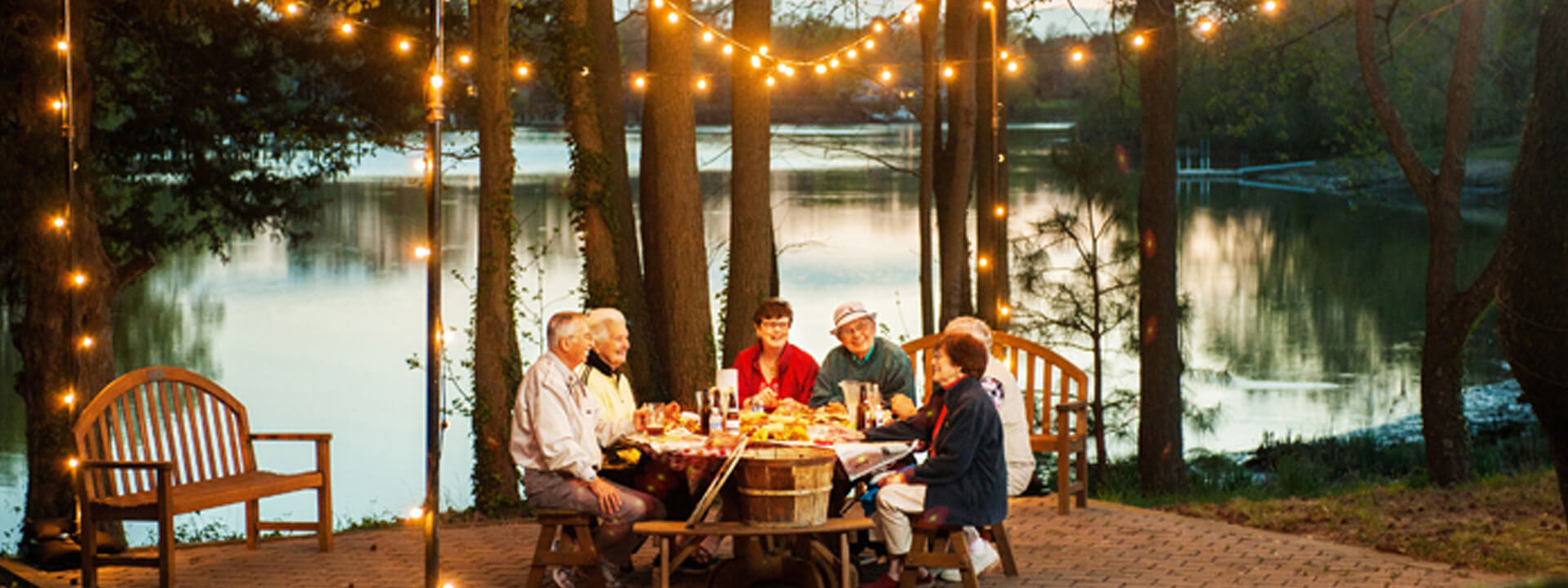 Residents enjoying a meal outdoors by the water