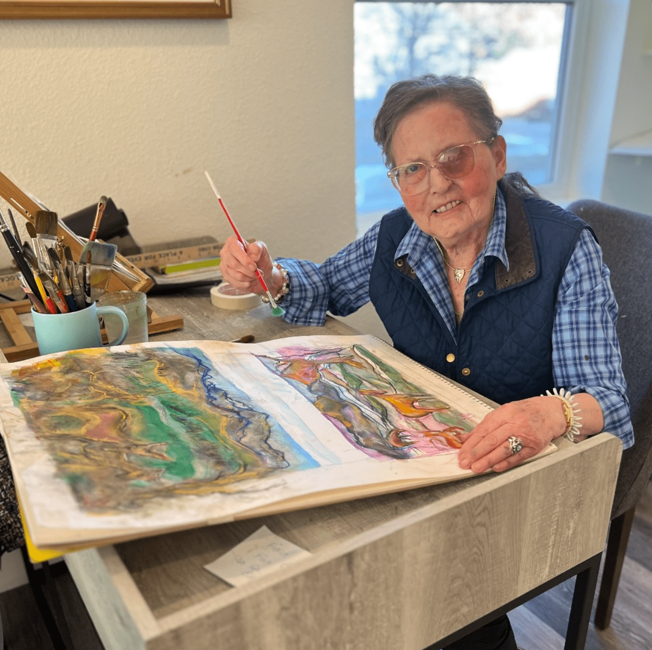 Resident engaged in art activity at a table