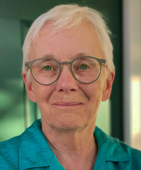 Elderly woman with glasses smiling warmly