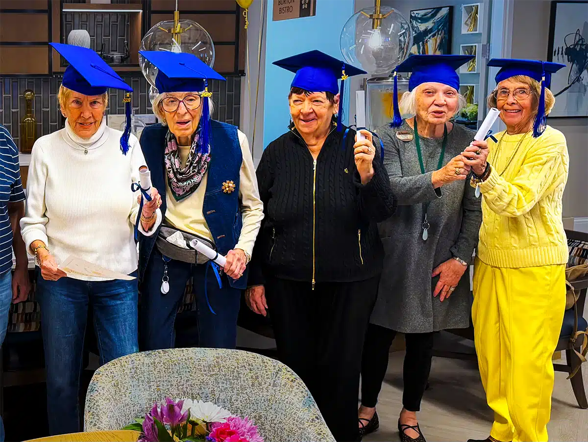 Residents celebrating with graduation caps