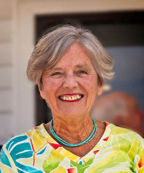 Smiling elderly woman wearing a colorful shirt