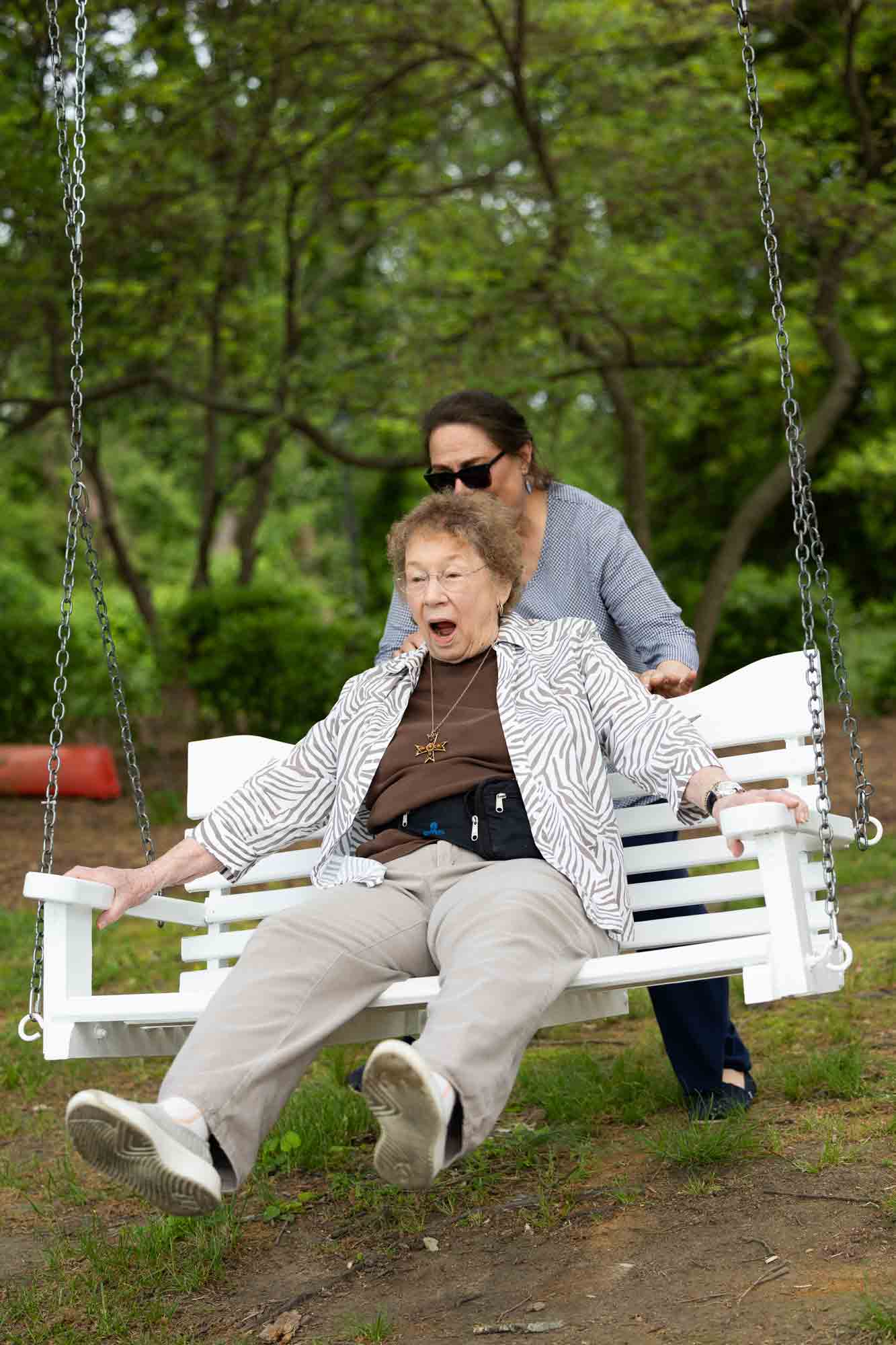 Residents enjoying a swing in a garden