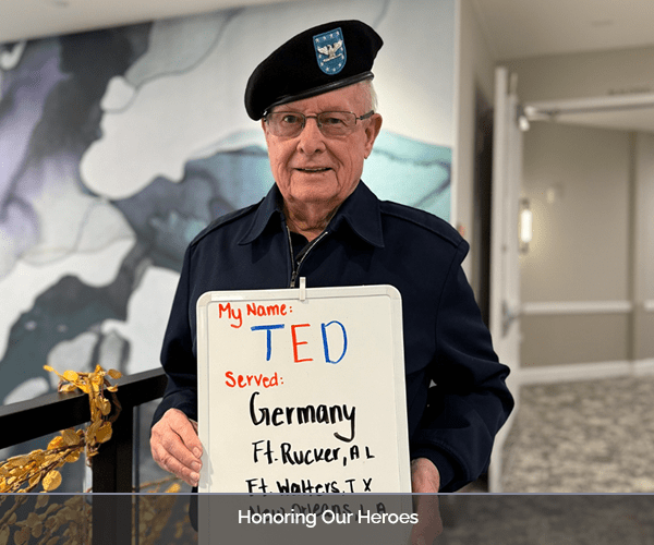 Resident holding a sign about their service in Germany