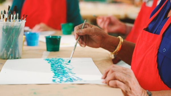 Close-up of a resident painting in an art activity