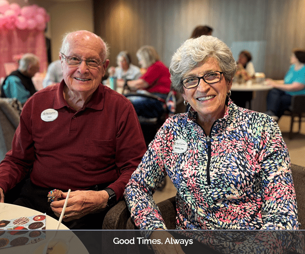 Two smiling residents enjoying a social moment