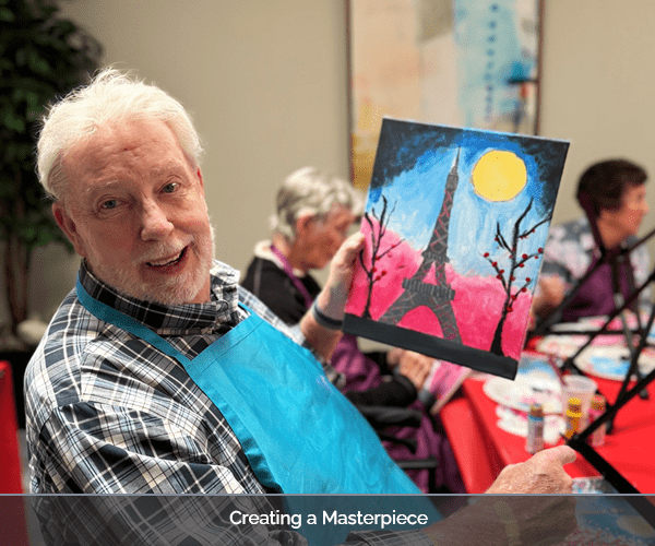 Resident painting in an activity room