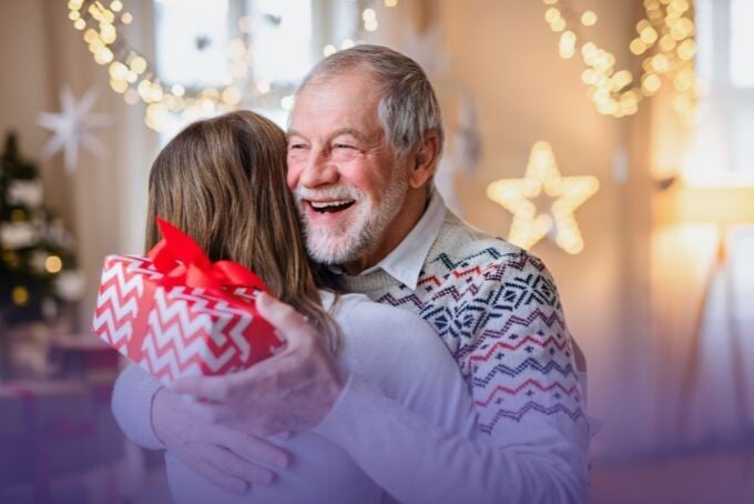 Resident and staff member sharing a joyful hug during a celebration