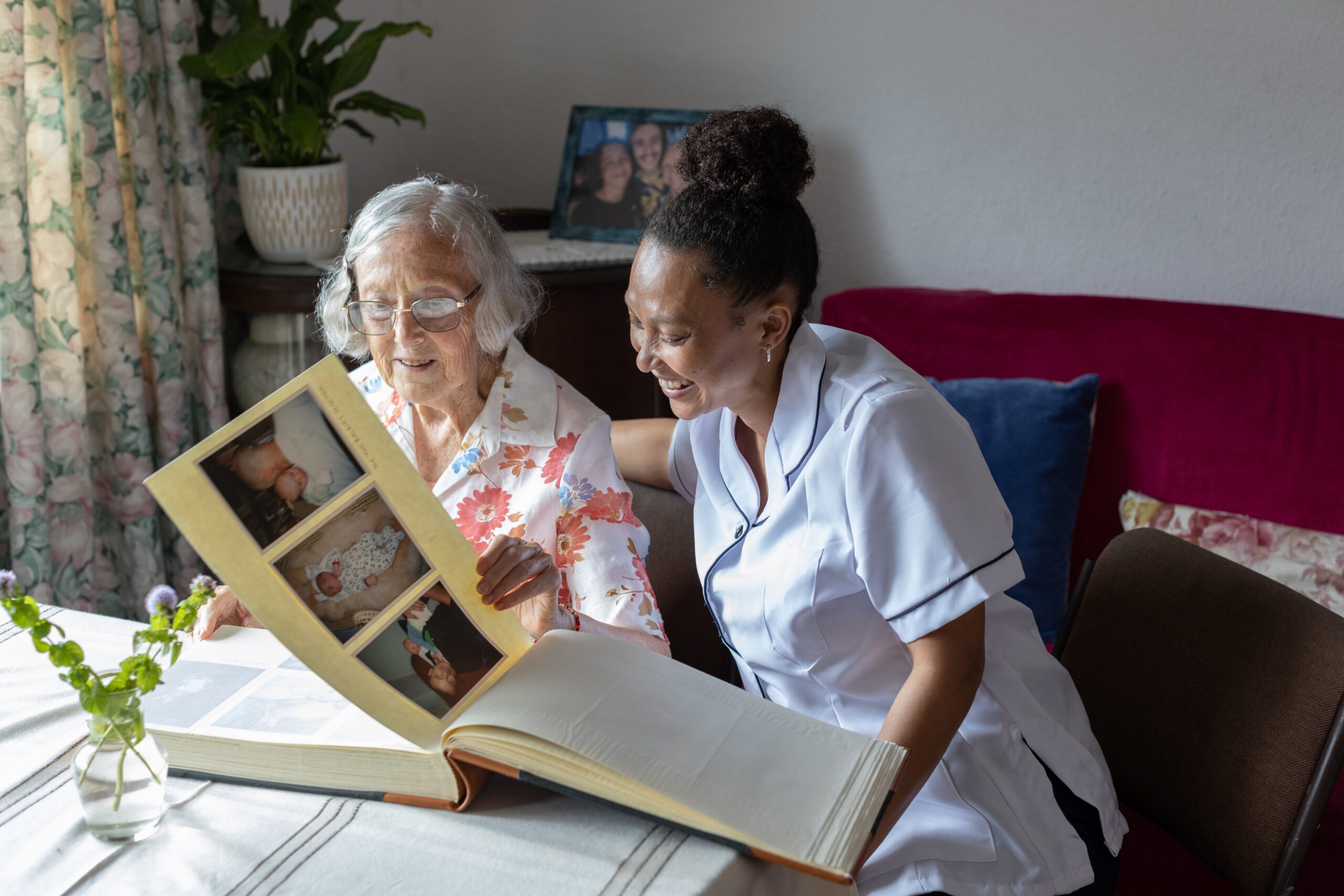Staff and resident enjoying a photo album together