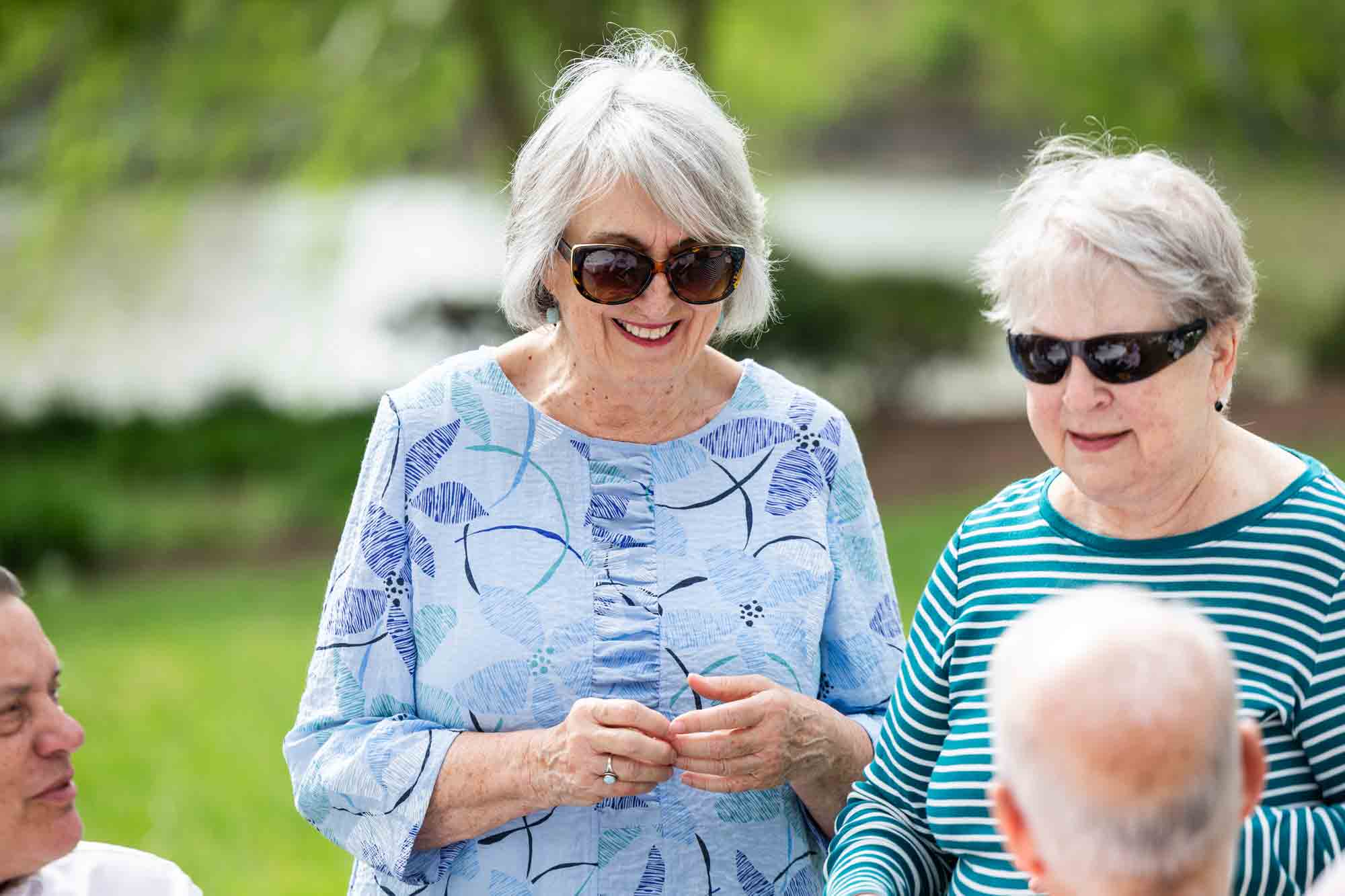 Two residents socializing outdoors in a garden