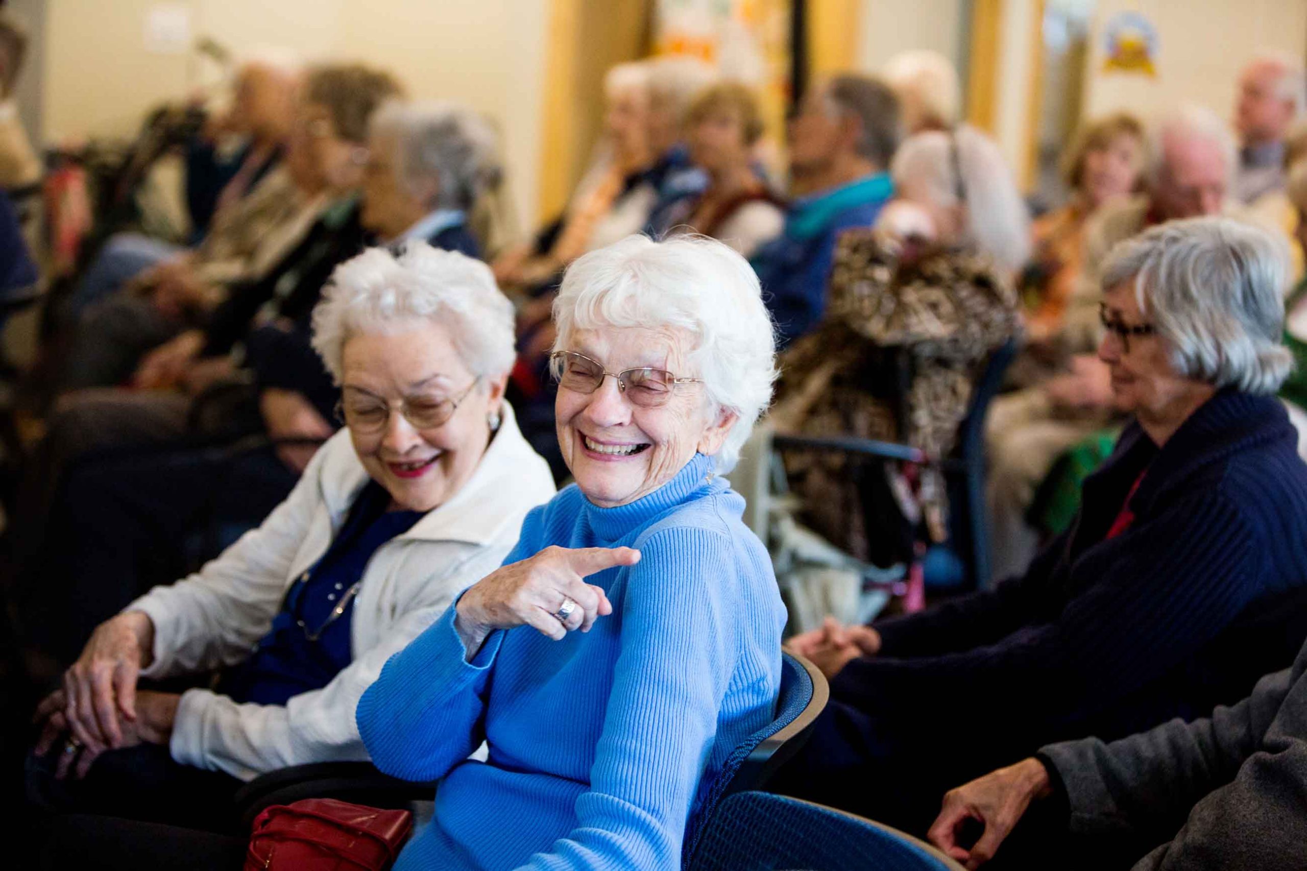 Happy residents enjoying an event in a common area