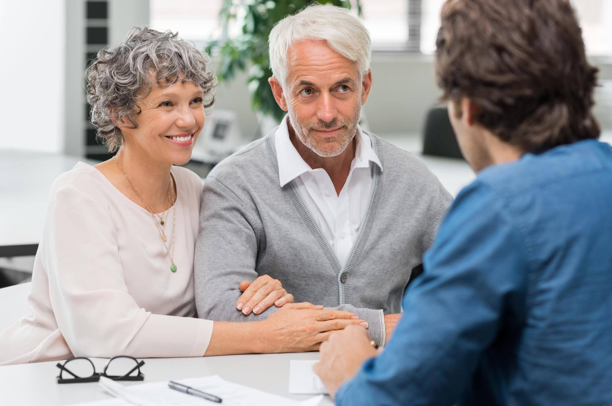 Two seniors in a meeting with a staff member