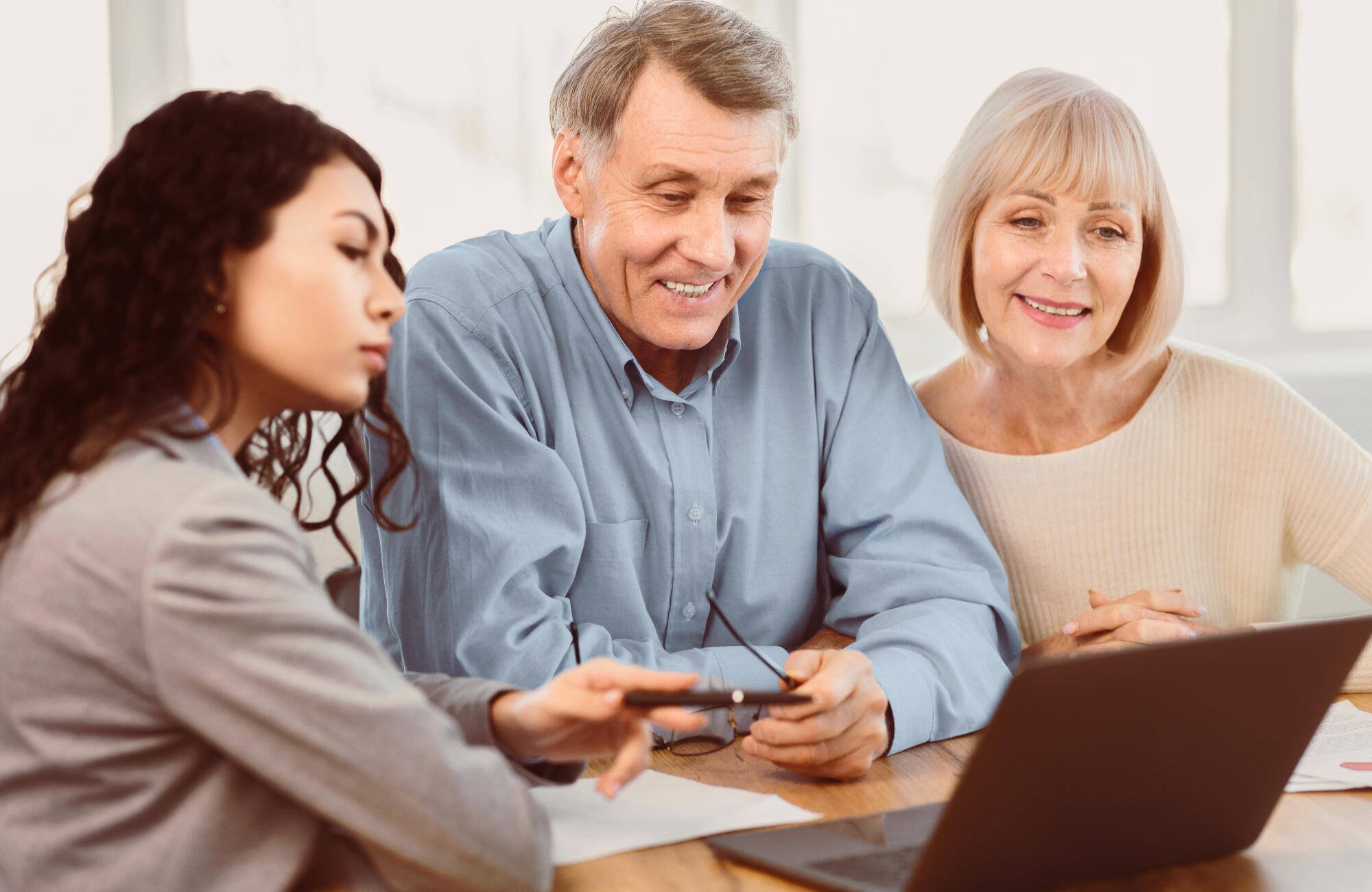 Residents and staff interacting over a laptop
