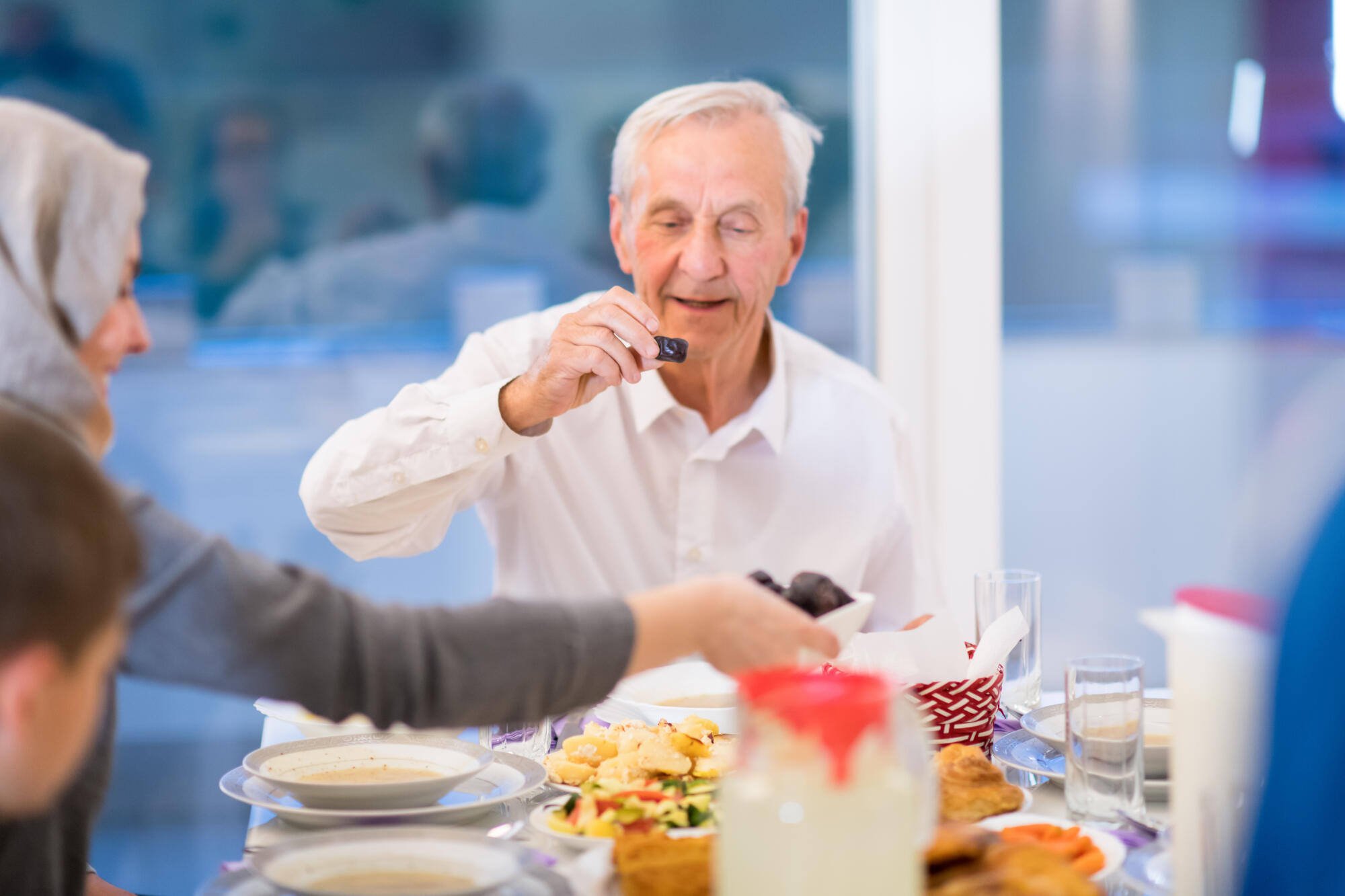 Residents enjoying a meal together at a dining table