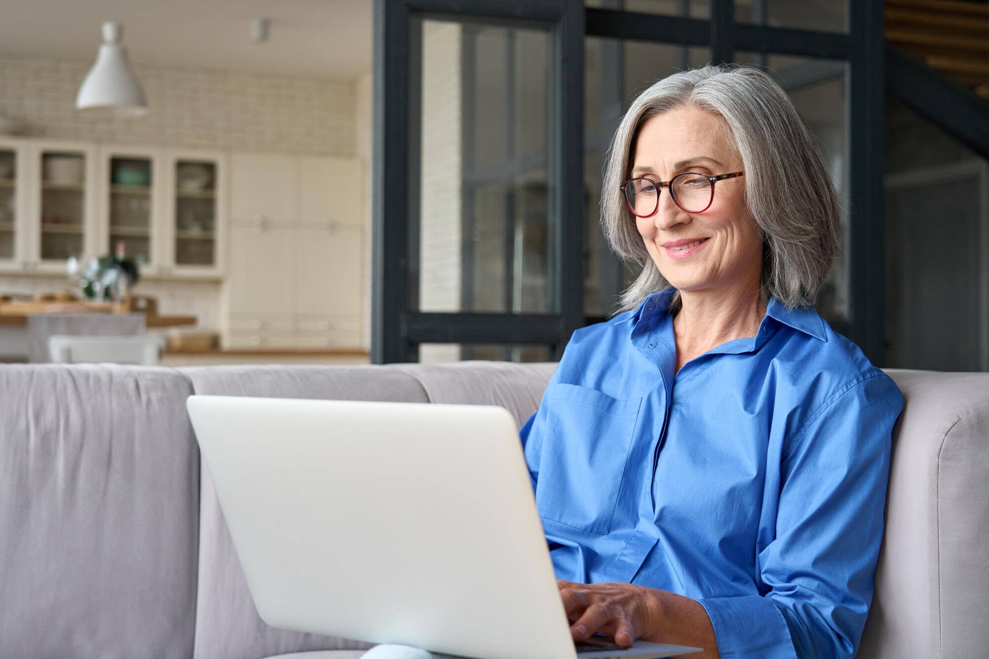 Resident using a laptop in a comfortable indoor space