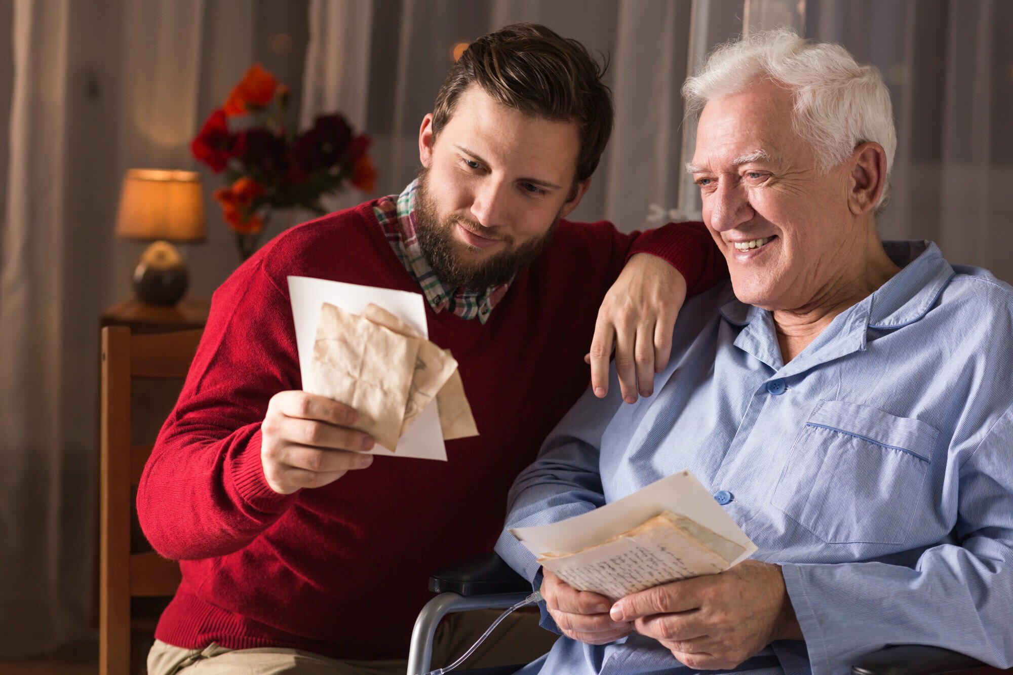 A young man and senior man sharing letters