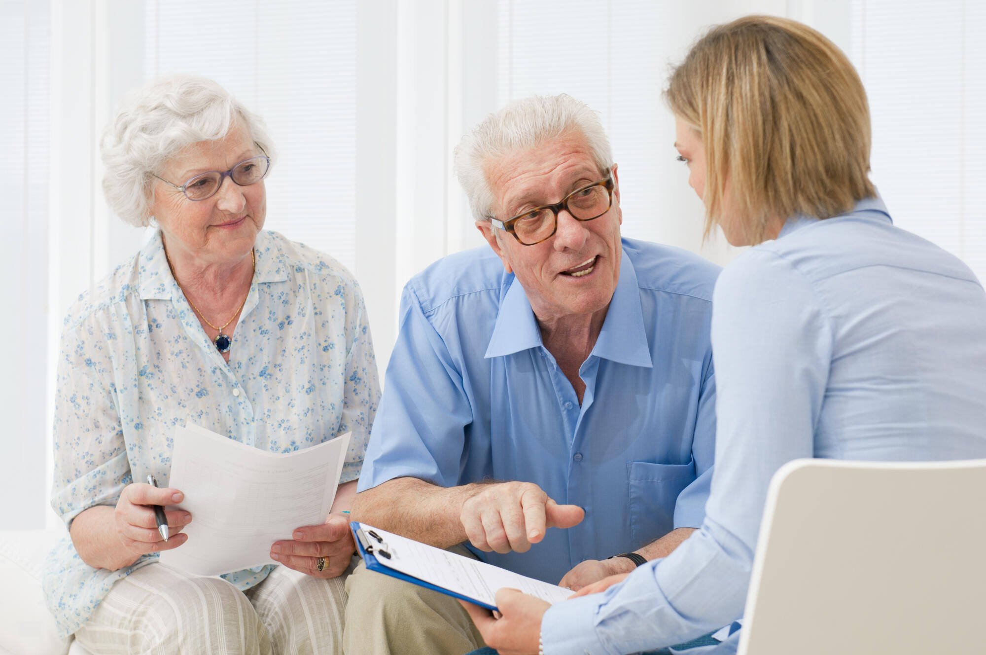 Residents engaging with staff in a bright room