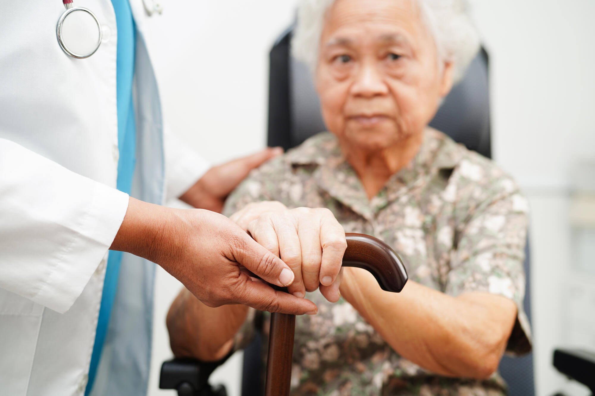 A healthcare professional assisting an elderly resident