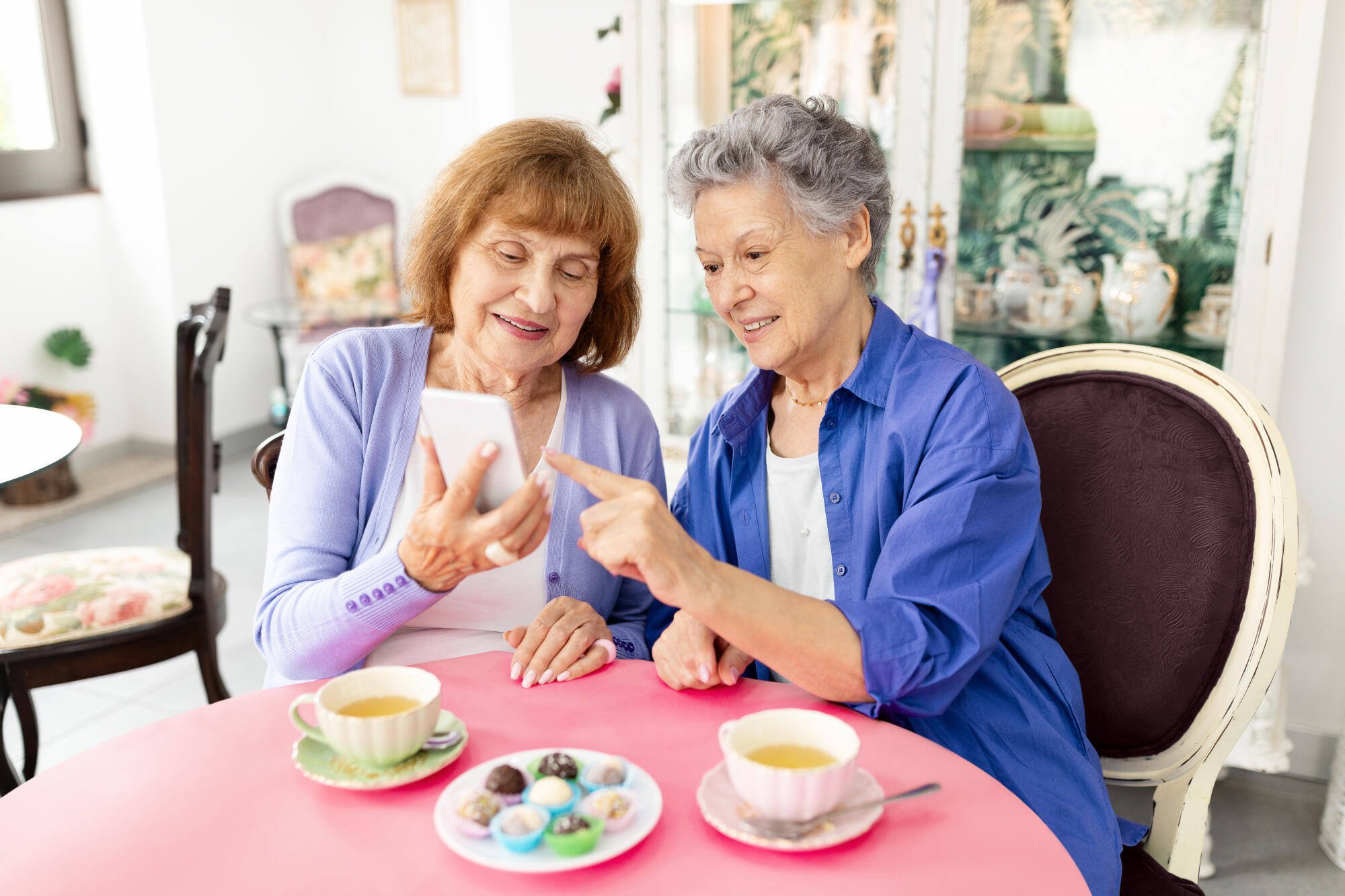 Two women enjoying dessert and conversation at a table