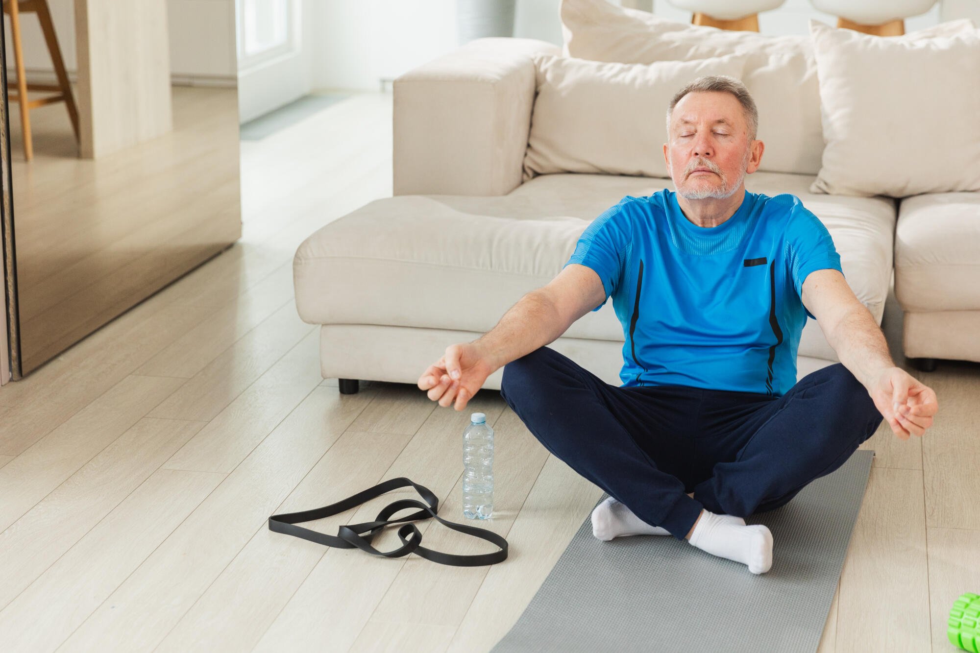 Senior man meditating in an activity room