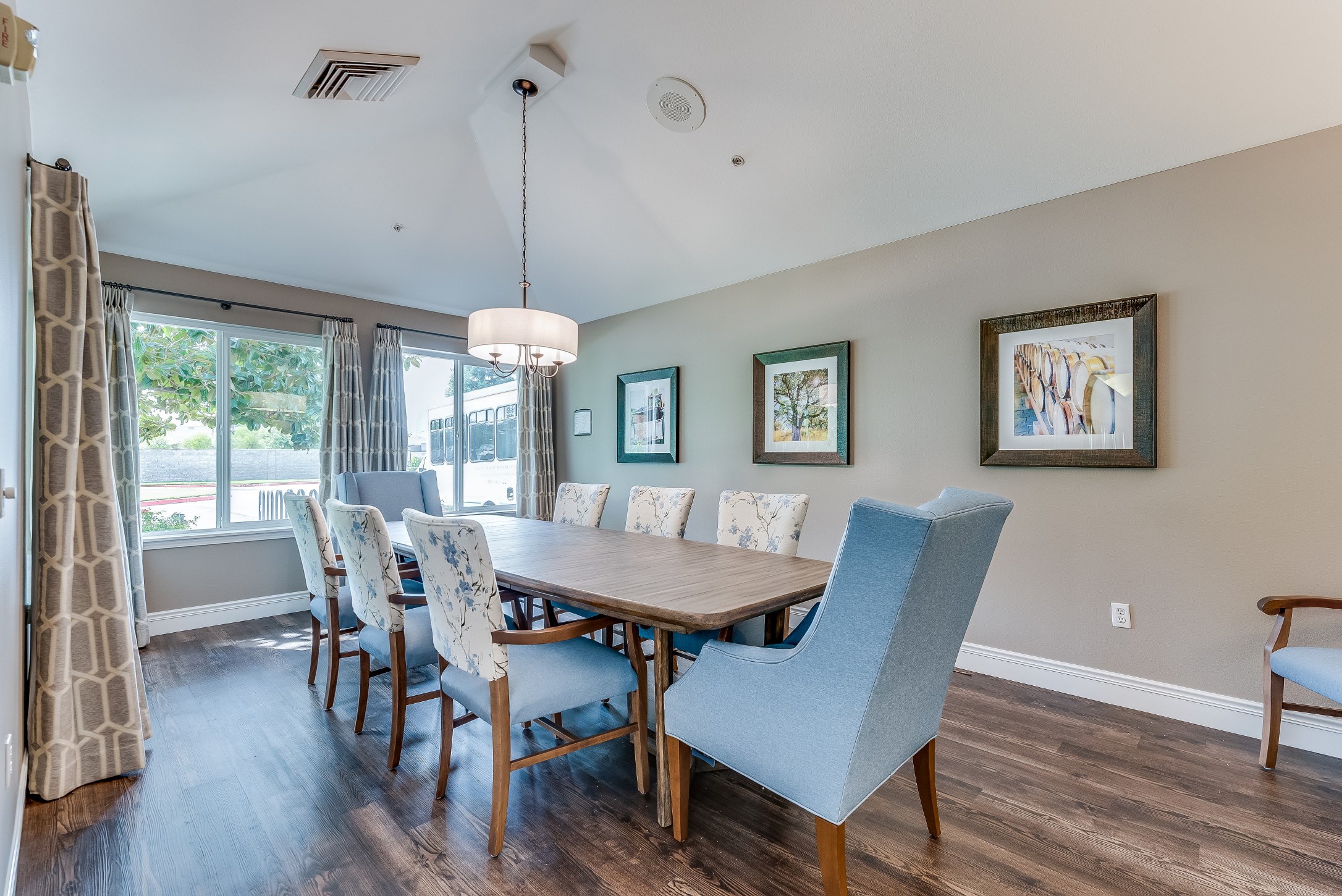Bright dining room with a large wooden table and decorative chairs