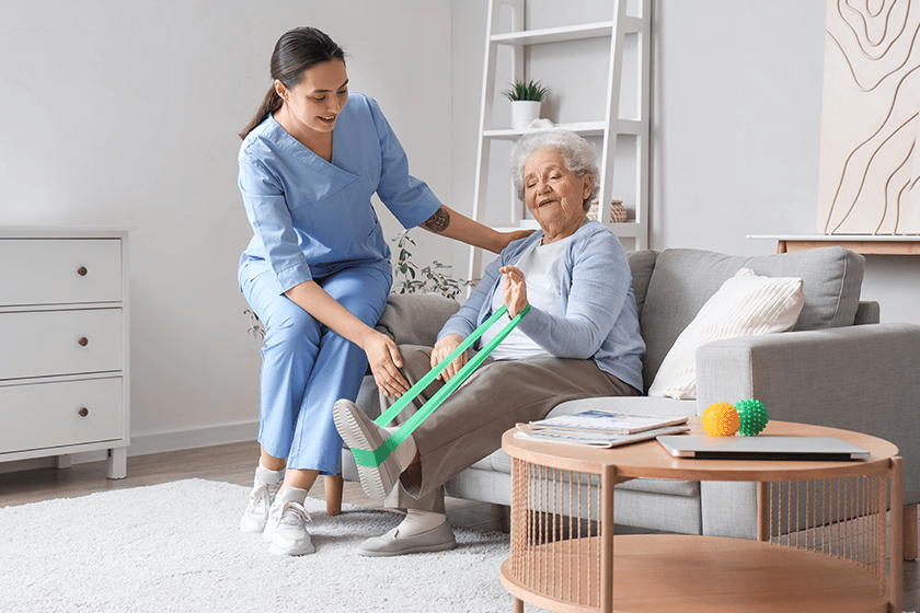 Staff assisting a resident with stretching exercises