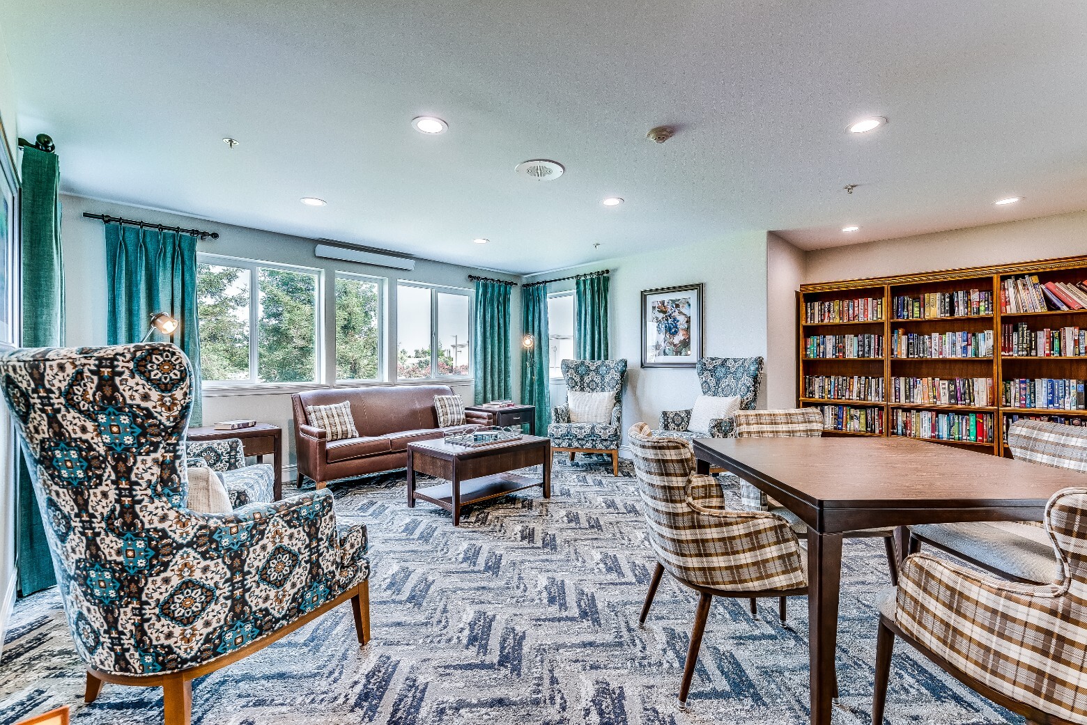 Common area with comfortable seating and bookshelves