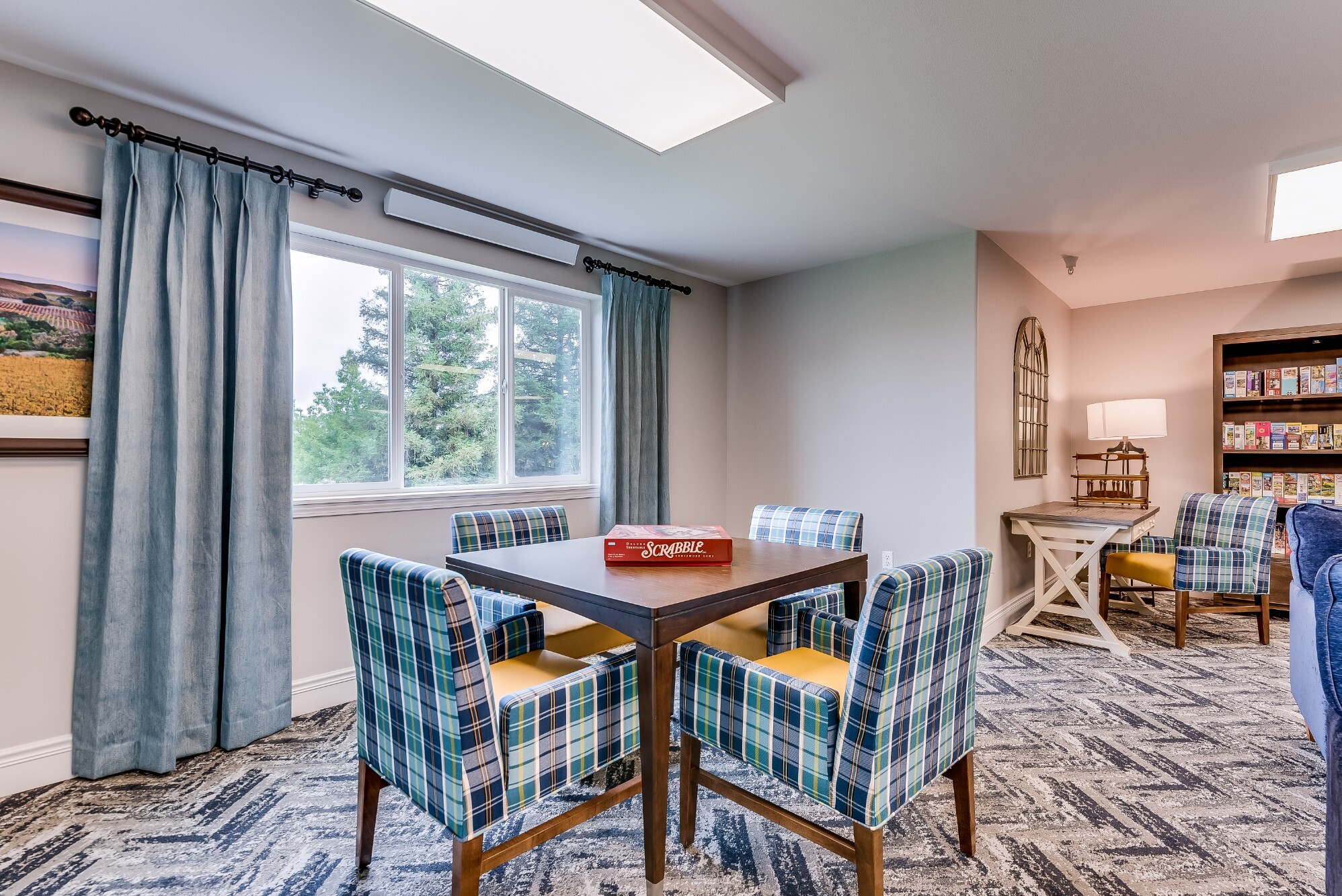 Bright common area with seating and board game