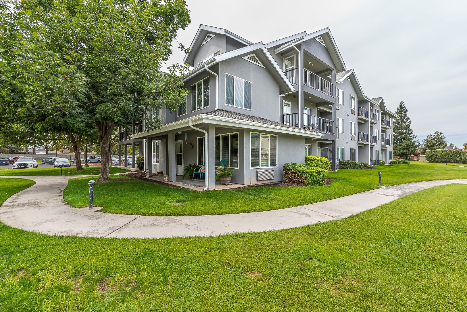 Exterior view of a senior living facility with green lawns