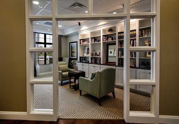 Cozy interior common area with bookshelves and seating