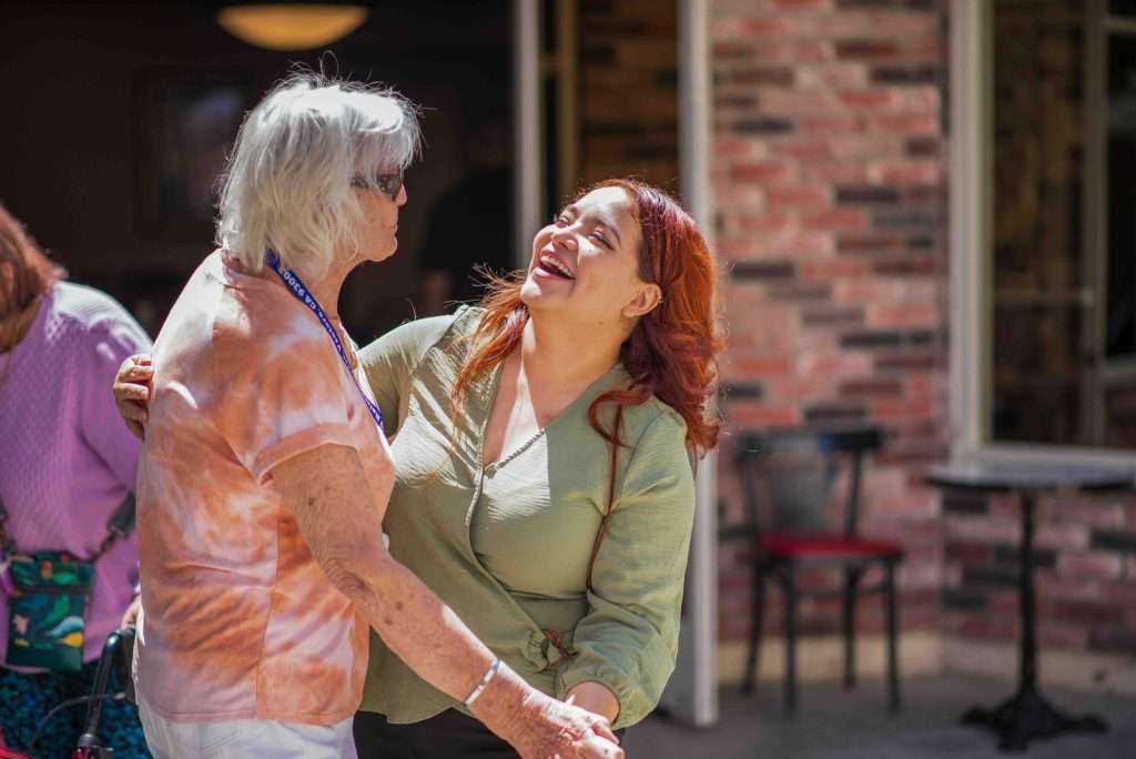 Residents engaged in a joyful dance activity
