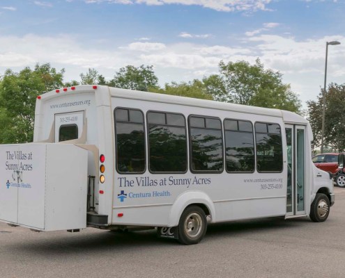 Facility shuttle bus parked outside.