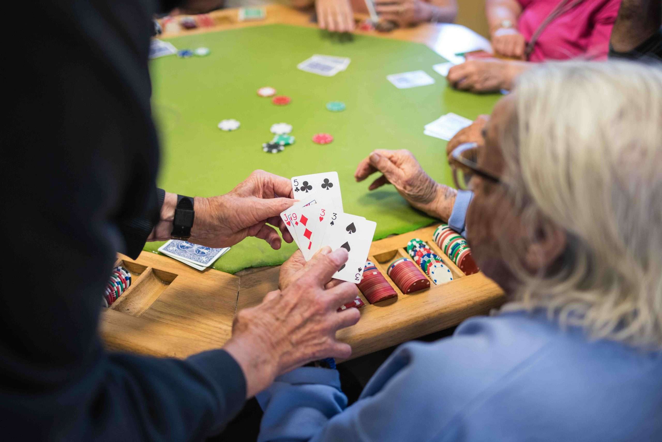 Residents playing cards in a vibrant common area