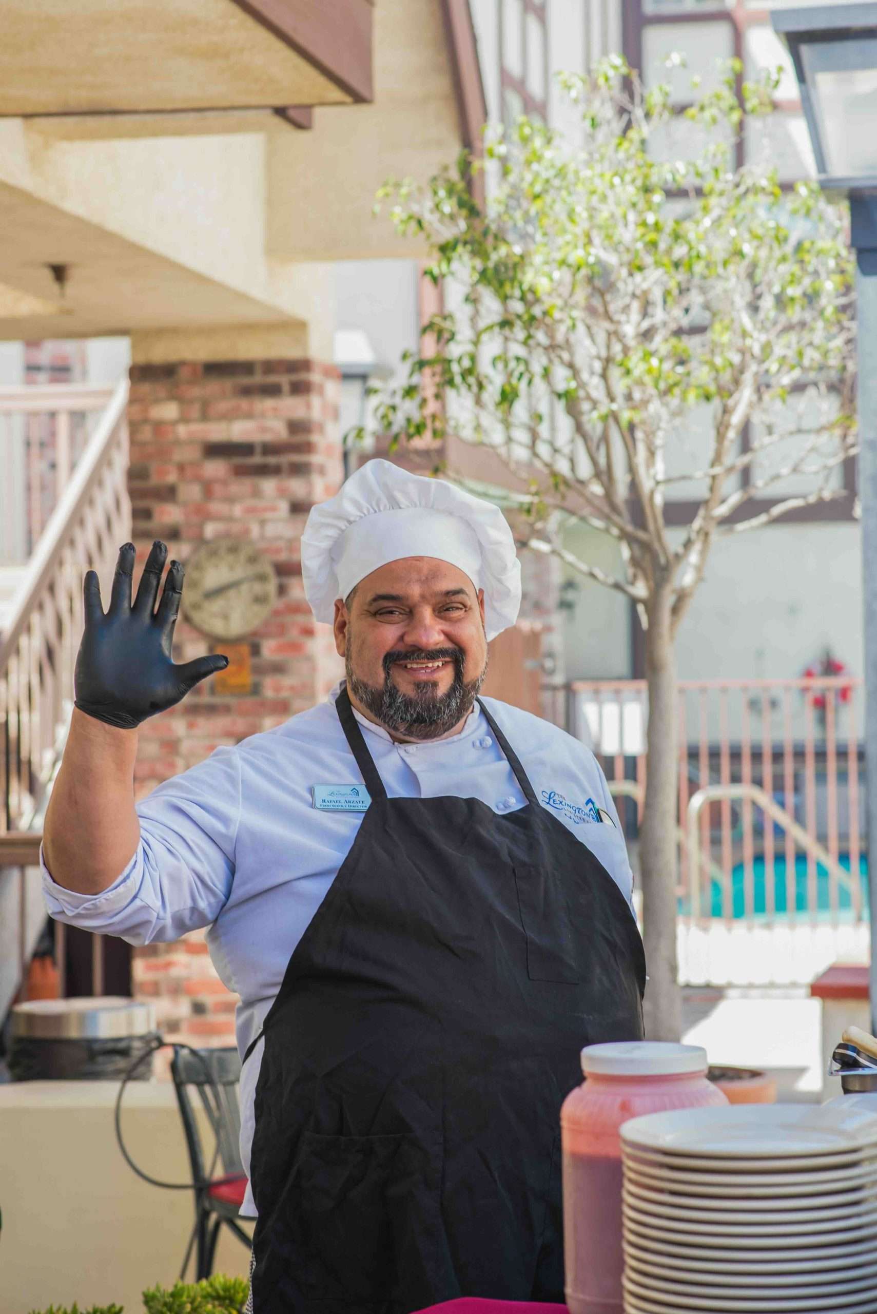 Chef waving at an outdoor cooking event