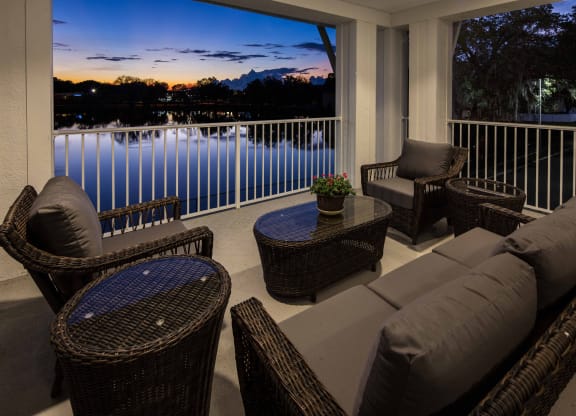 Outdoor seating area with a view of the lake at sunset