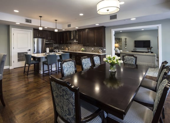 Bright dining area with a large table and kitchen