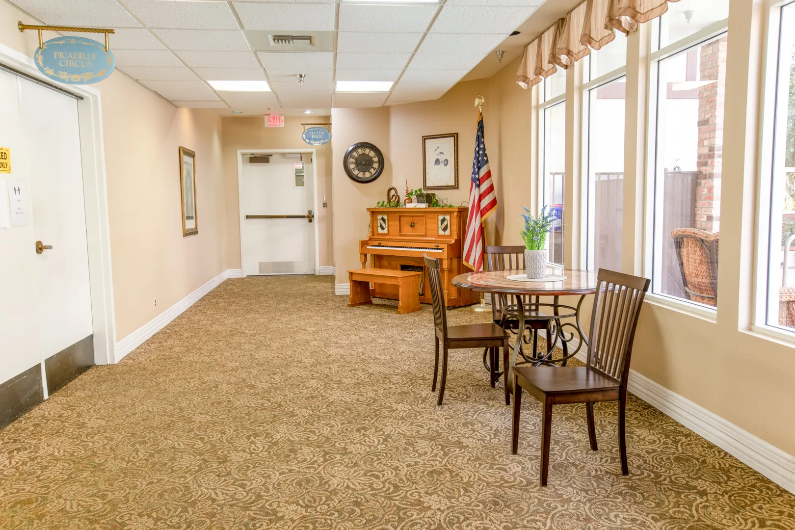 Interior hallway with a piano and seating area