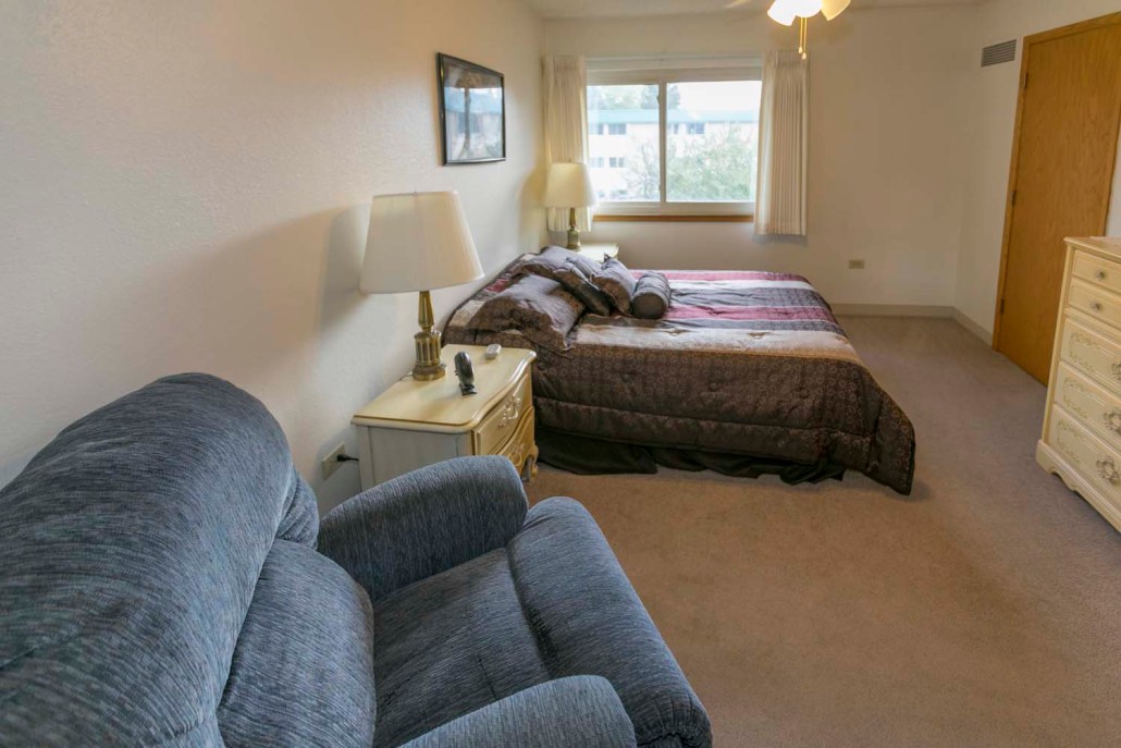 Cozy private resident room with a bed and seating area