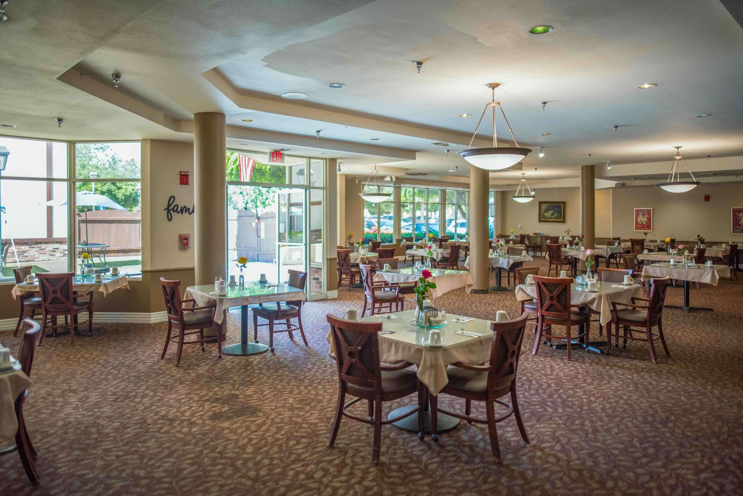 Dining area with tables set for residents