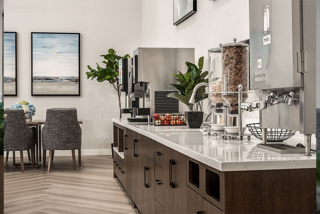 Brightly lit kitchen area with snacks and seating