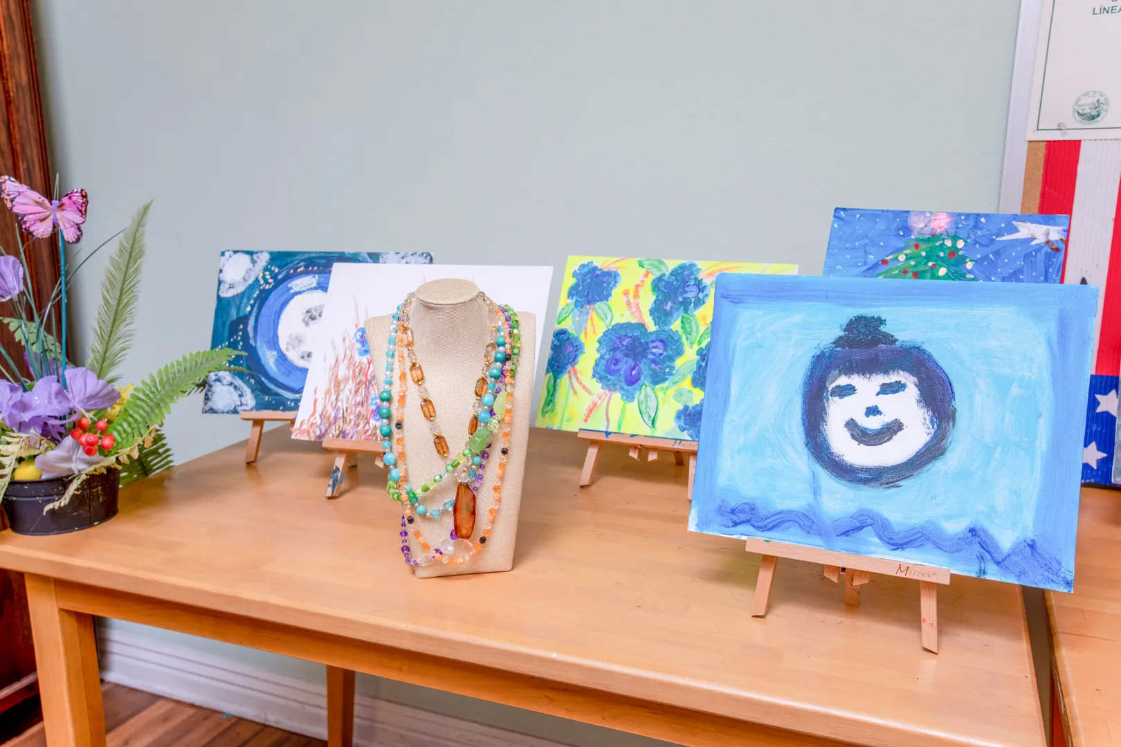 Art displays and handmade jewelry on a table