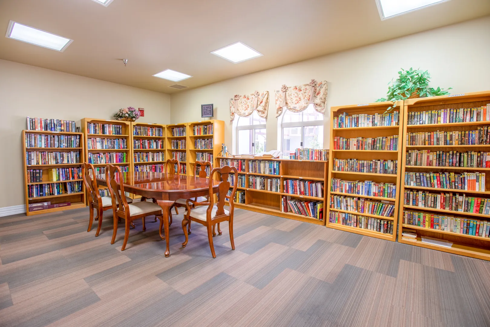 Bright library interior with wooden bookshelves and tables