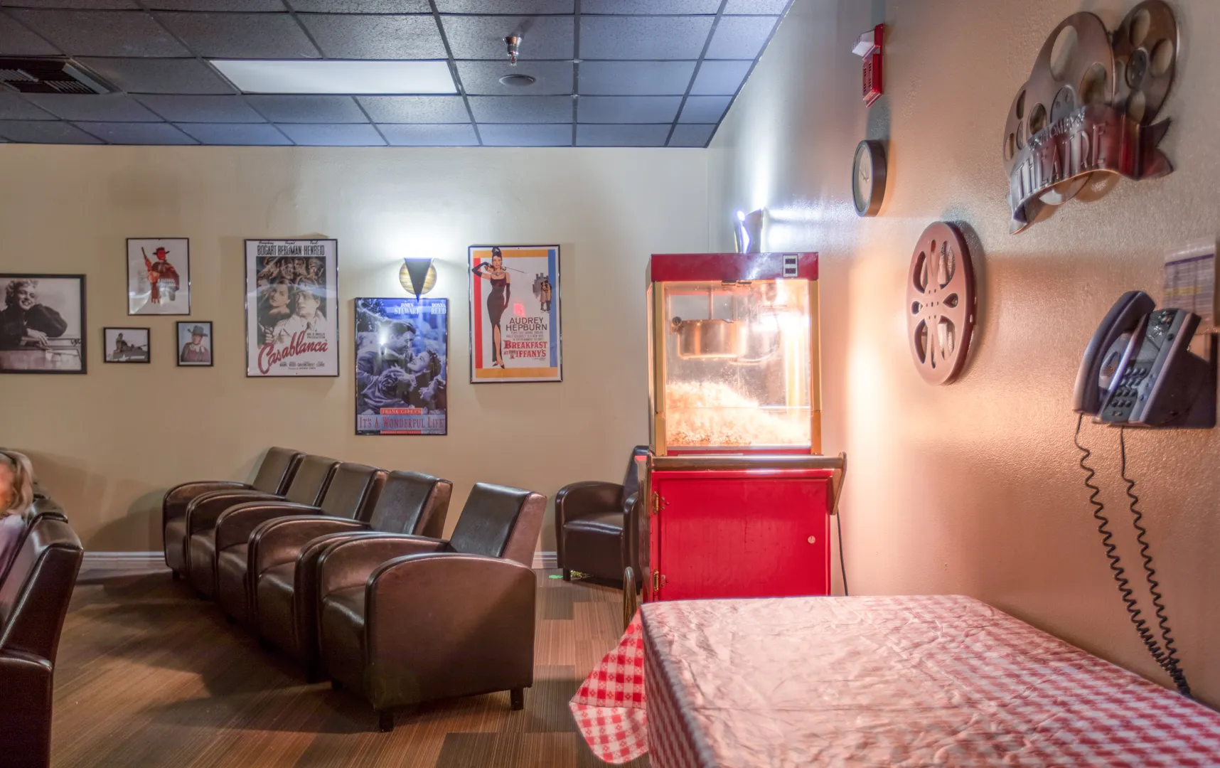 Cozy lounge area with movie posters and popcorn machine