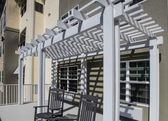Outdoor seating area with a pergola and rocking chairs