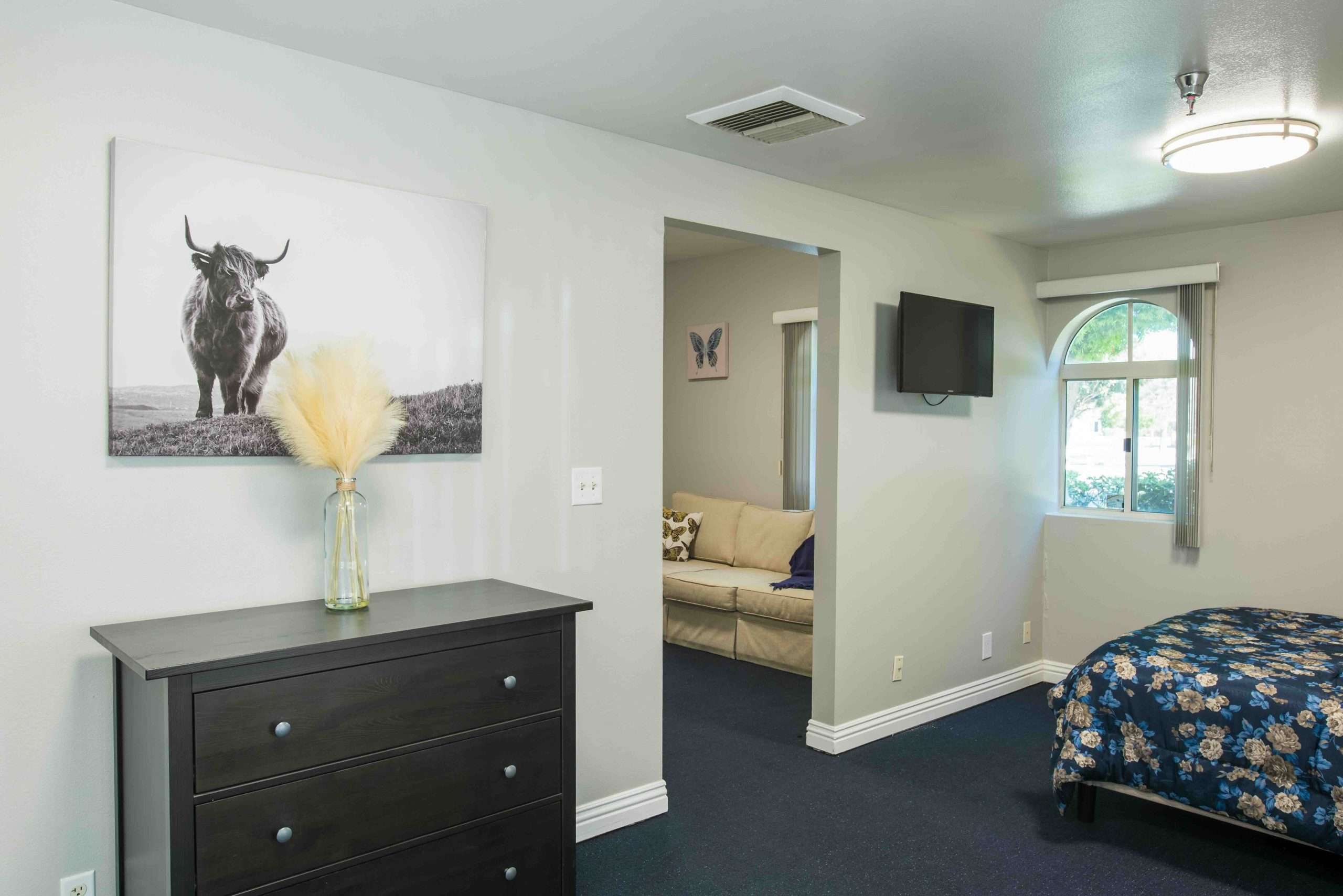 Interior view of a resident room with a bed and decor