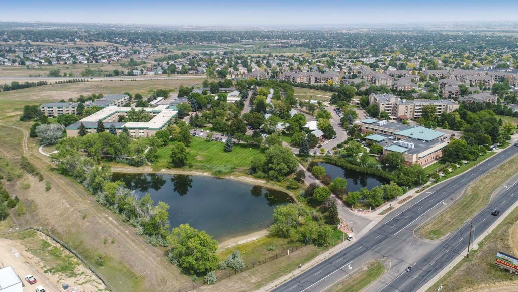 Aerial view of The Villas at Sunny Acres with gardens and ponds