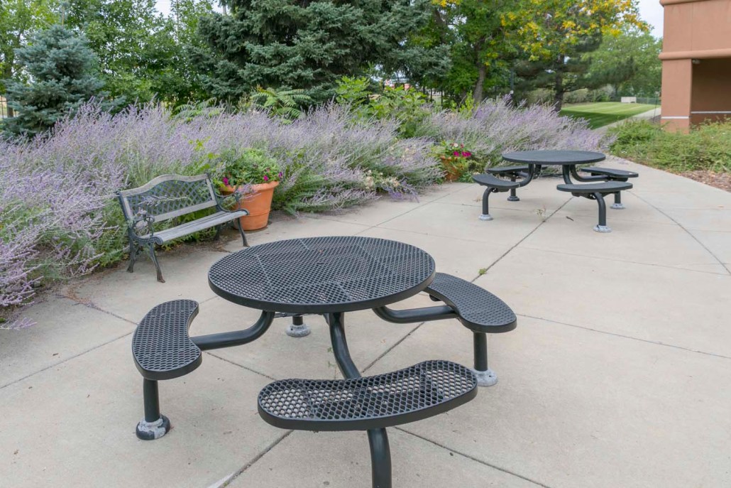 Outdoor seating area with tables and benches