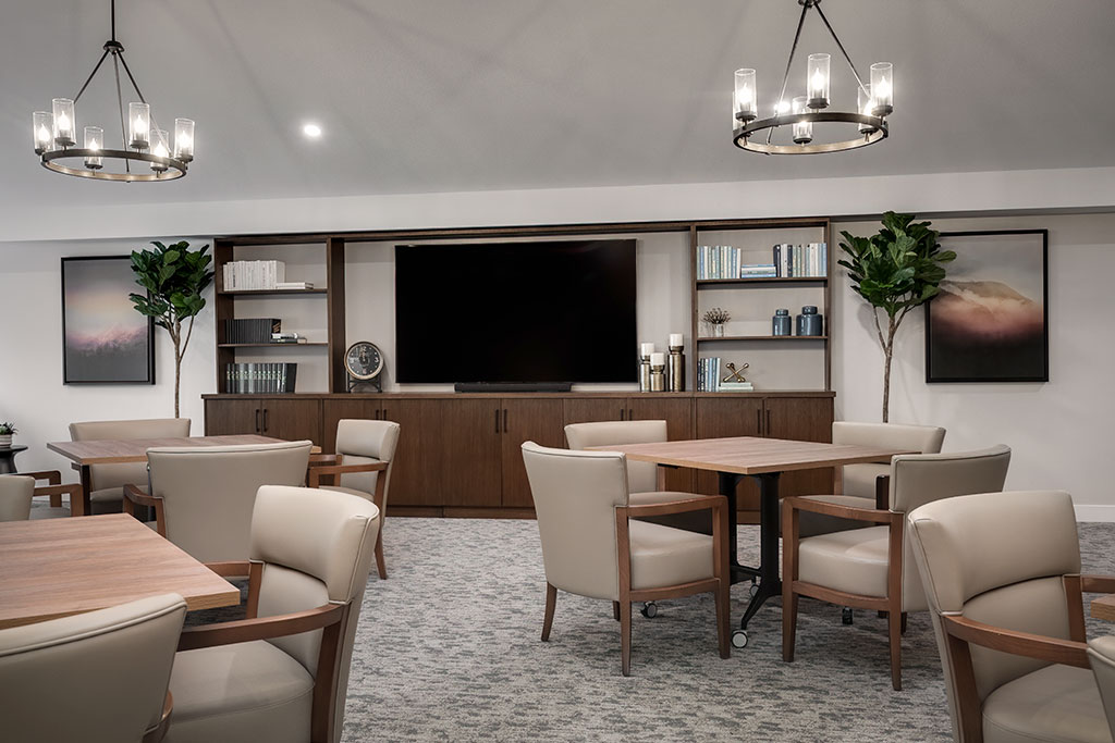 Common area with seating and decor in a senior living facility